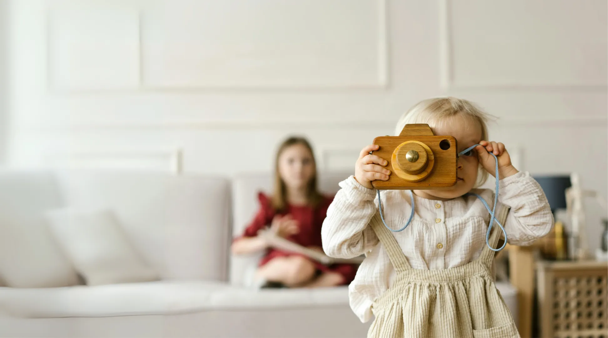 Barn leker tryggt hemma med barnvakt i bakgrunden - barnpassning via Nanny.nu